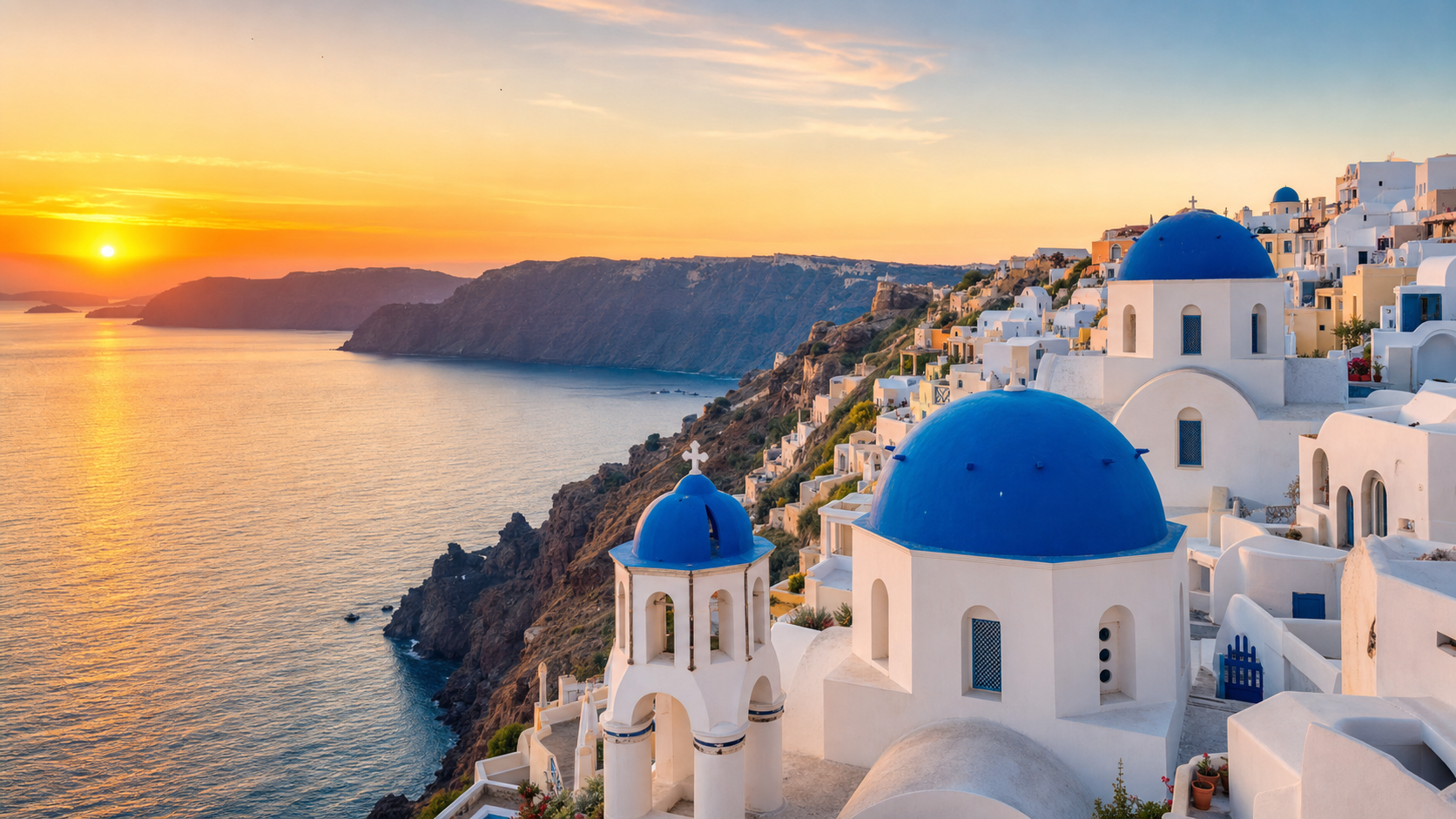 Santorini caldera and blue domes at sunset